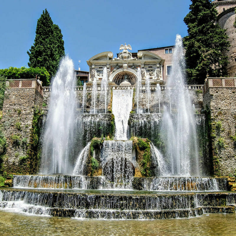 Villa de Este fountains & greenery in front of a brick bridge designed by landscape architects