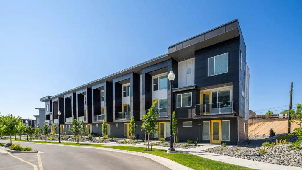 Lotus Anthem townhomes, dark cladding and glass railings, part of Clearfield’s multifamily neighborhood.